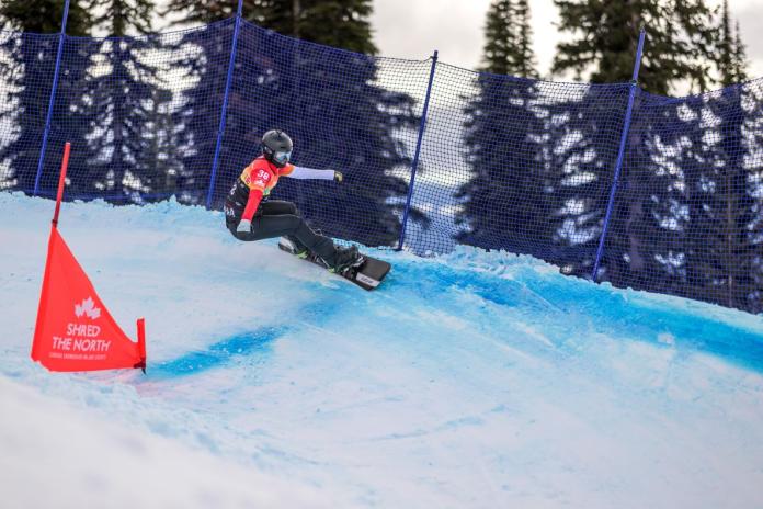 A male Para snowboard athlete competes 
